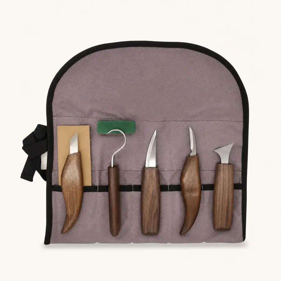 CarveKind 8-piece wood carving kit laid out: five black walnut-handled knives, leather strop, polishing wax and canvas roll bag
